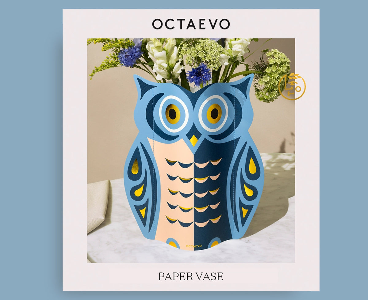 Packaging of an owl-shaped paper vase in blue, peach and gold by Octaevo.