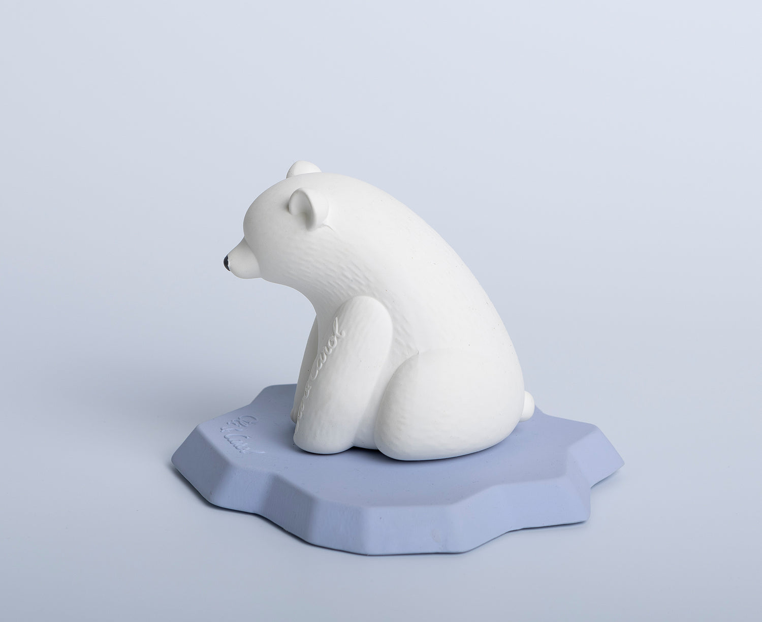 White polar bear chewable toy on a blue base of ice by Oli &amp; Carol.