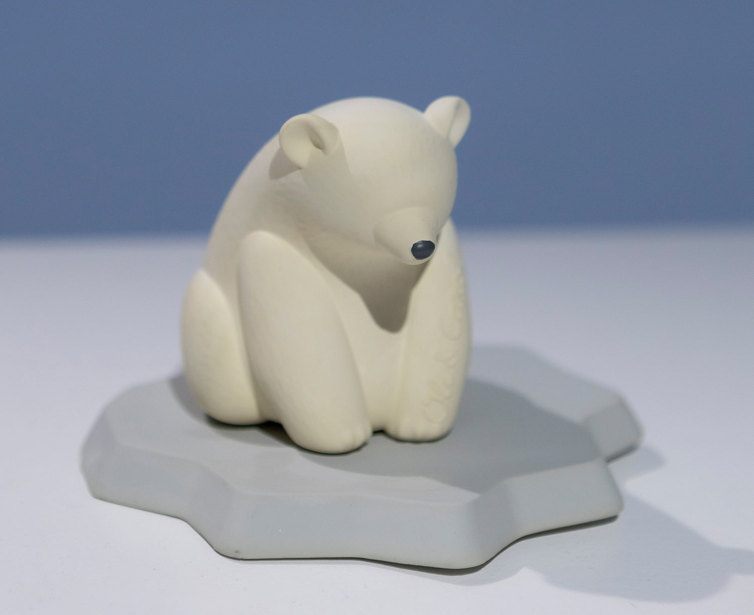 White polar bear chewable toy on a blue base of ice by Oli &amp; Carol.