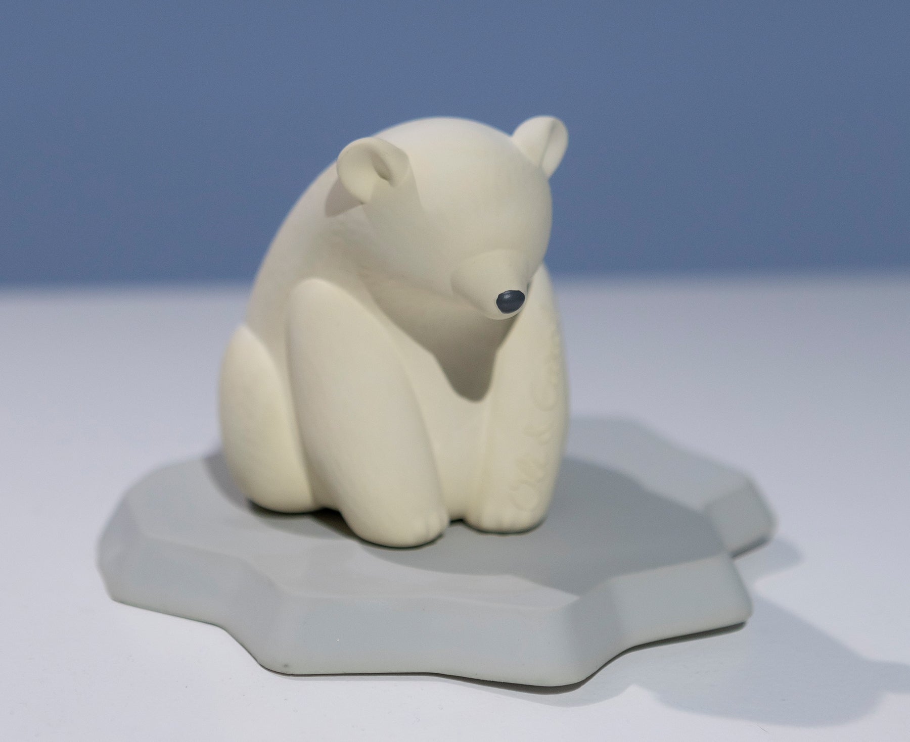 White polar bear chewable toy on a blue base of ice by Oli &amp; Carol.