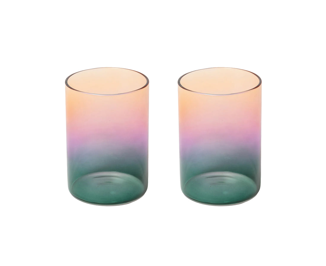 Two matching translucent tumblers with a vertical gradient design transitioning from peach-pink at the top to purple in the middle and teal-green at the bottom, shown on a plain white background.