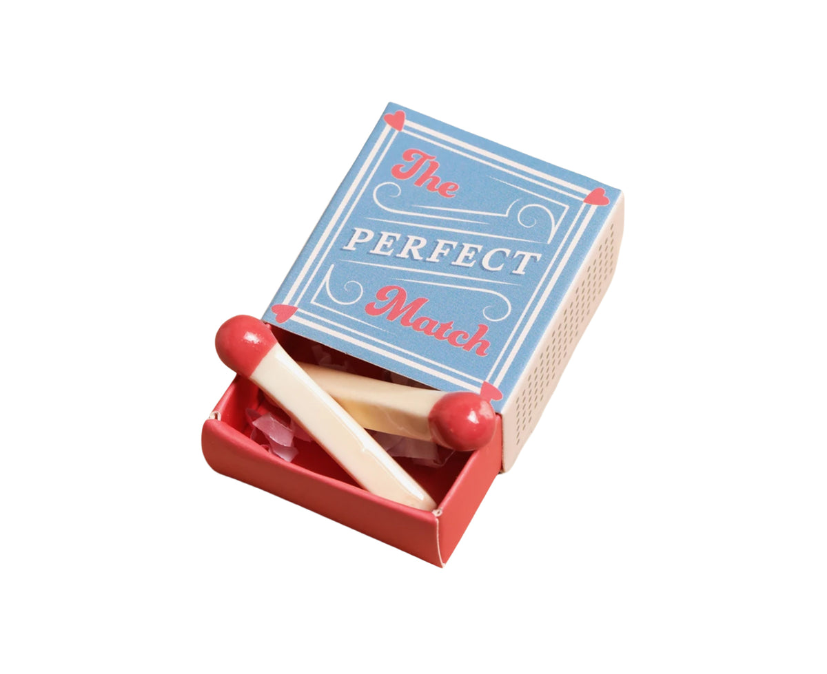 A miniature toy matchbox set with a light blue lid printed with &