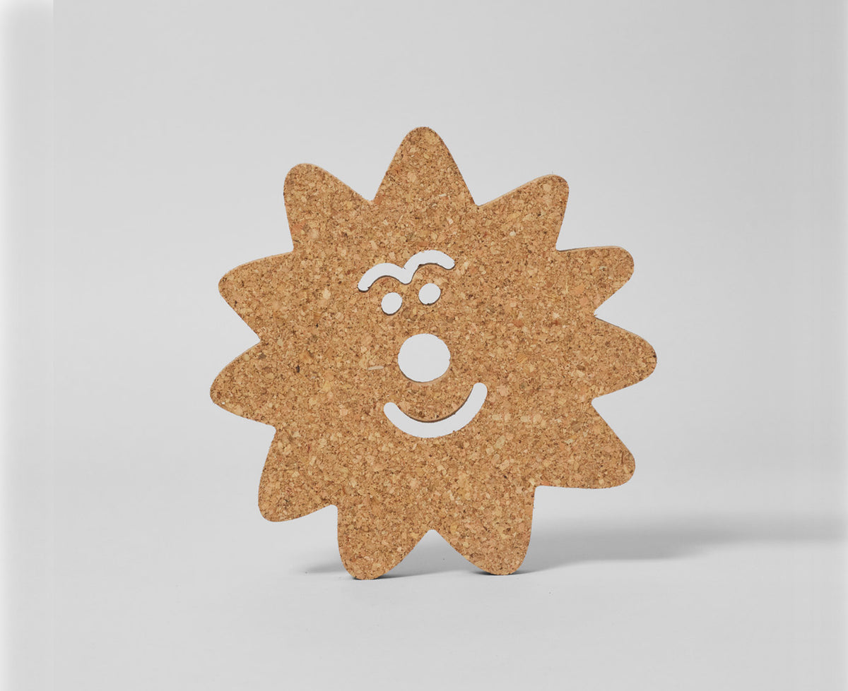 A star-shaped cork board with a smiling face cutout, standing on a light gray background.