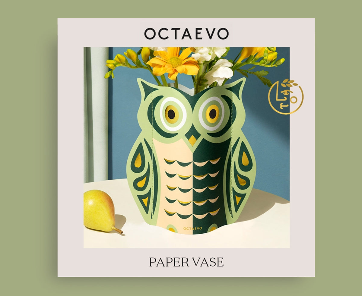 Flat packaging showing owl-shaped paper vase featuring a stylized graphic design in green, peach, and gold by Octaevo.