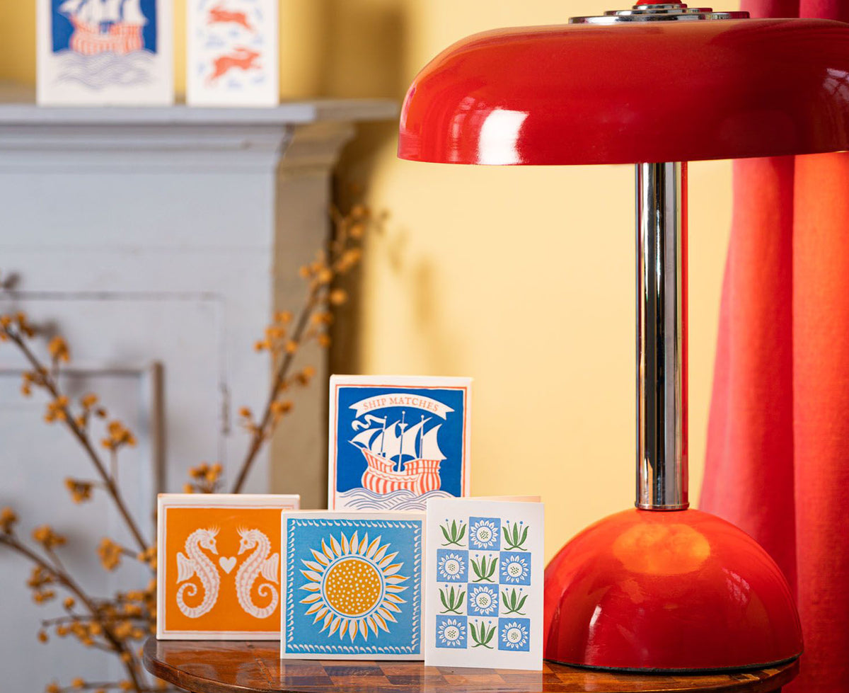 Square Matches by Archivist Gallery with a red table lamp